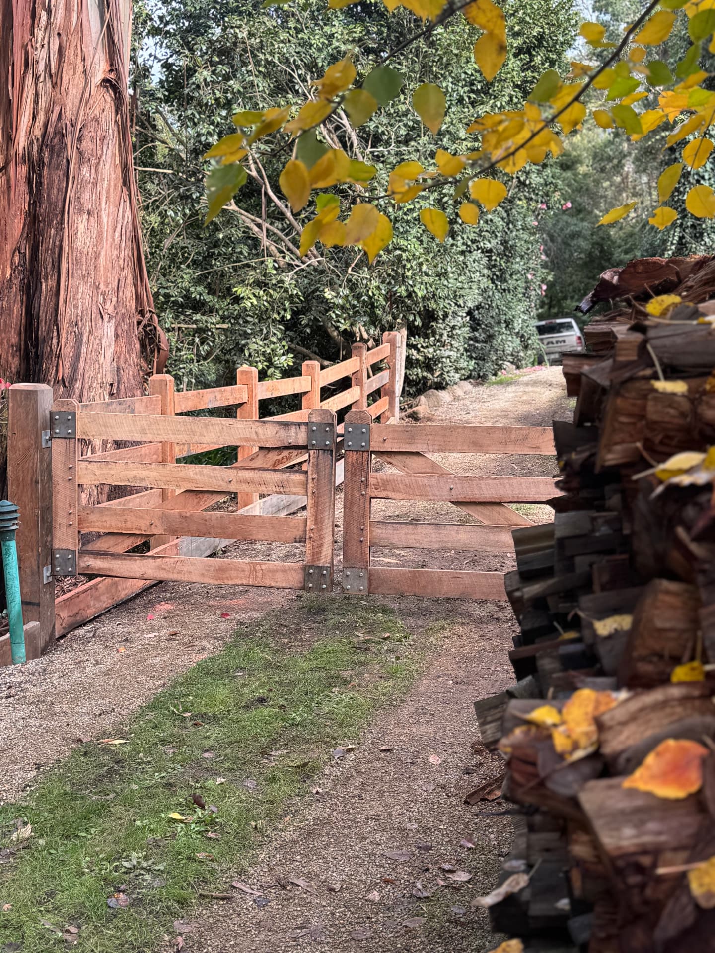 Pair of handcrafted timber gates with black steel hardware