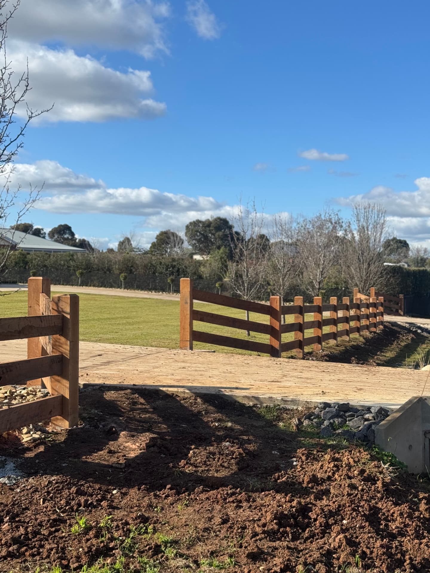 Ironbark post and rail fence along a driveway crossing