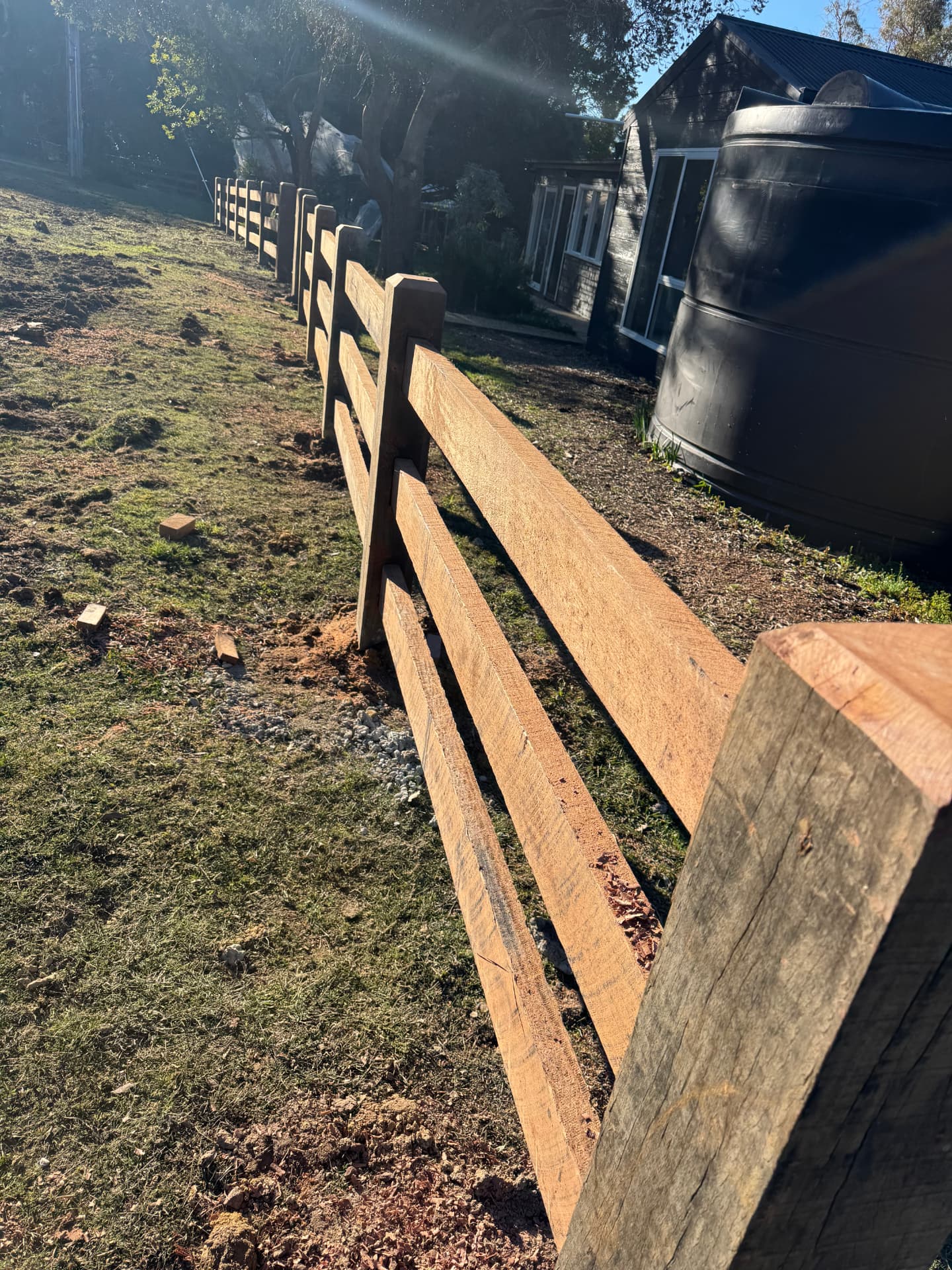 Macrocarpa cypress post and rail fence catching the morning sun