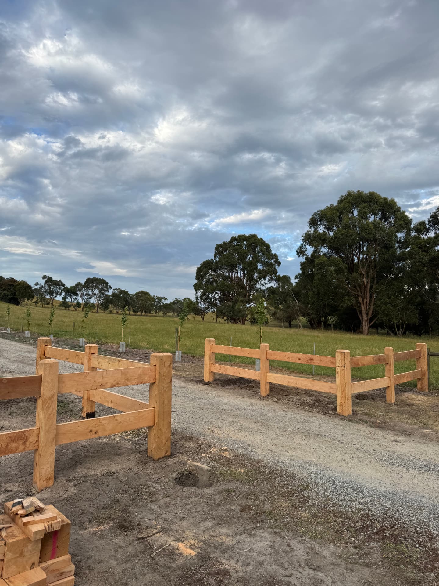Macrocarpa cypress post and rail fence on an acreage driveway